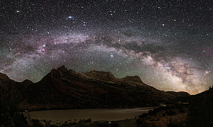 brown mountain under starry sky photography