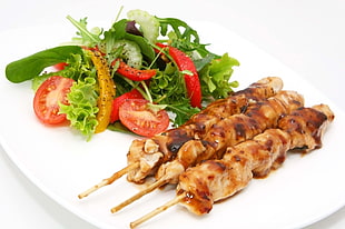 white ceramic plate of three barbecues with vegetables