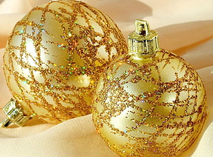 close-up photo of two gold-colored baubles HD wallpaper