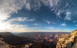 photo of blue and gray sky under the brown mountains HD wallpaper