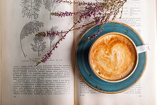 filled white ceramic teacup on saucer