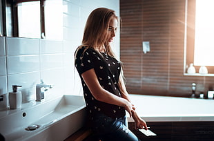 woman wearing black top leaning on sink HD wallpaper