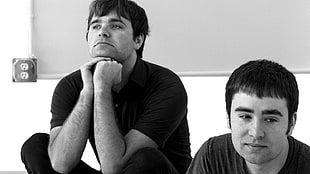 grayscale photo of two men sitting beside each other HD wallpaper