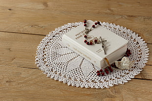 brown and white beaded rosary on white covered bible with doily HD wallpaper