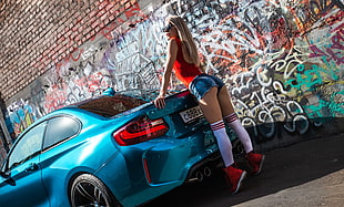 woman wearing blue short shorts leaning on blue coupe HD wallpaper