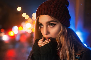 woman wearing knitted maroon bobble hat with brown blonde hair