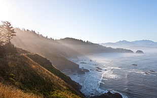 time lapse photography of brown mountains beside seashore