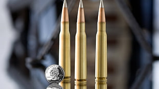 three rifle bullets, ammunition, coins, money, metal HD wallpaper