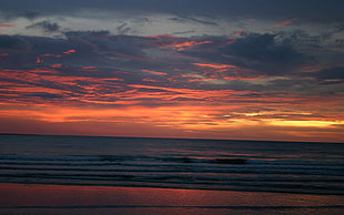 body of water during sunset