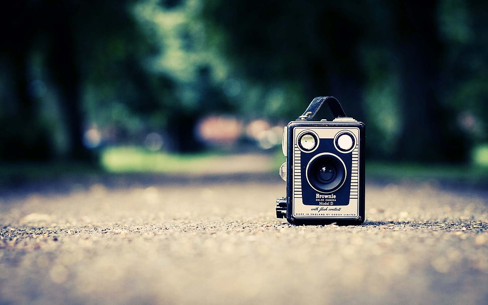 selective focus photography of gray and black camera on concrete road HD wallpaper