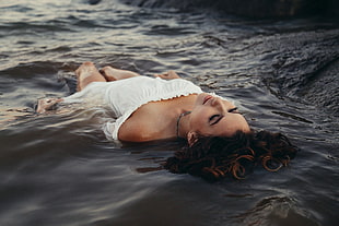 woman in white off shoulder dress lying on water HD wallpaper