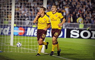 two Fly Emirates soccer player near goal