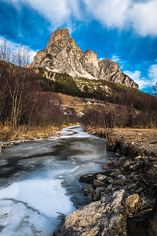 brown mountain and river, corvara, alta badia