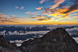 brown rock formation and white clouds