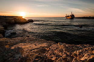 landscape photography of beige and black sailing ship on body of water during daytime