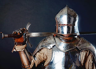 man in full metal war armour with sword