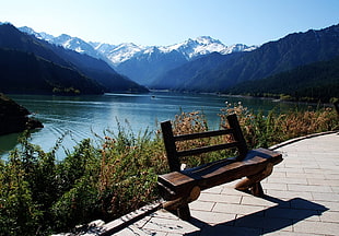 brown wooden bench overlooking mountains HD wallpaper