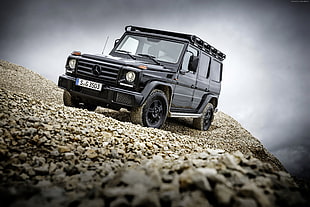 black Mercedes-Benz SUV on brown soil with stones HD wallpaper