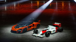 two red, orange, and white racing vehicles
