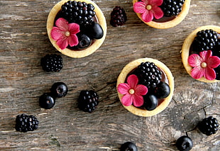 berry and flowers in three bowls