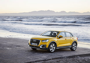 yellow Audi sedan on sand