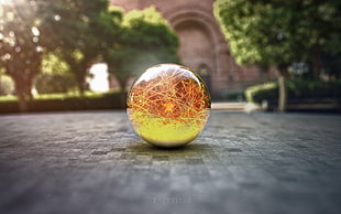 yellow and orange ball on grey concrete surface