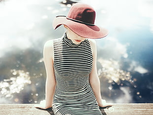 selective focus photography of woman in black and white striped sleeveless dress and red hat HD wallpaper