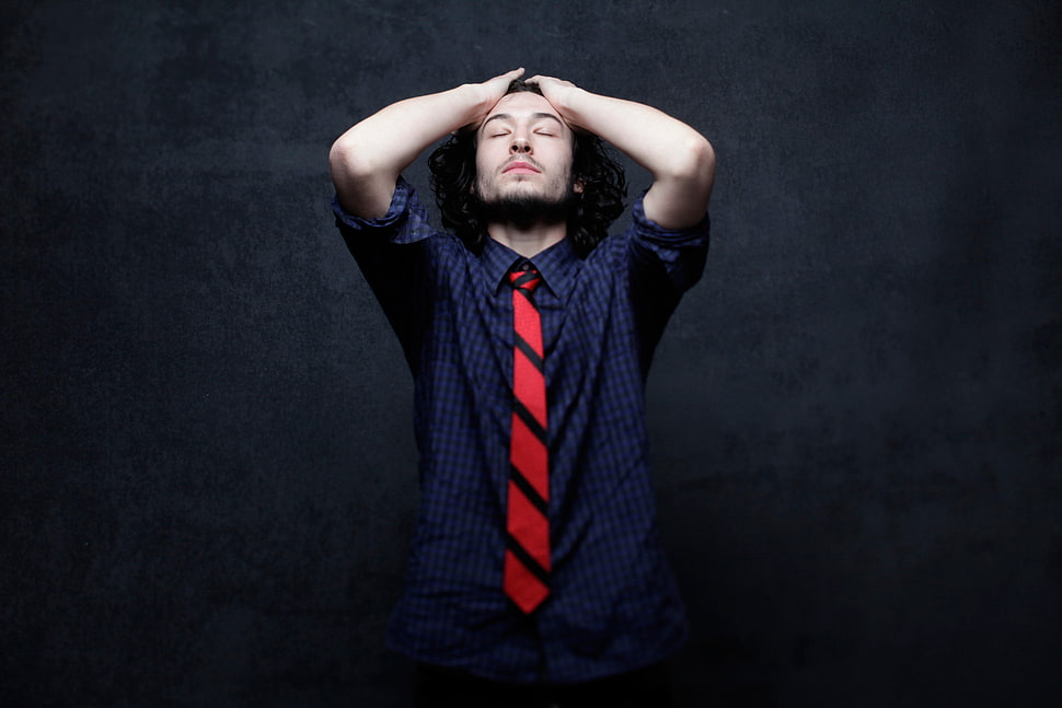 man in blue dress shirt holding his forehead HD wallpaper