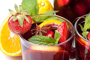 strawberry and tea in clear drinking glass