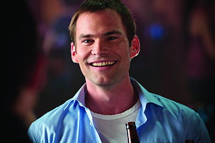 man wearing white top and blue polo