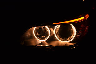 lit car headlight HD wallpaper