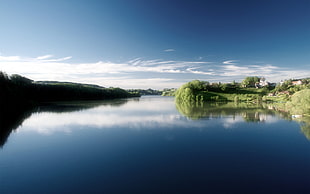 landscape photo of mountain and body of water under blue clear sky