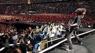 man playing guitar on stage