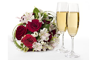 two clear glass champagne flutes and rose bouquet HD wallpaper