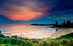 time lapse photography of sea shore under blue sky