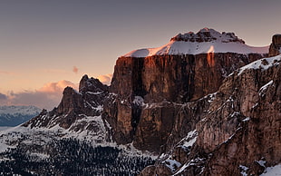 brown cliff with snow