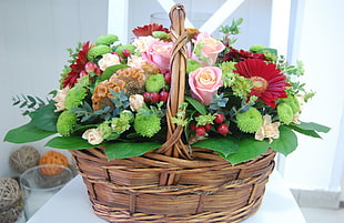 bouquet of pink, green and red flowers in brown woven basket HD wallpaper