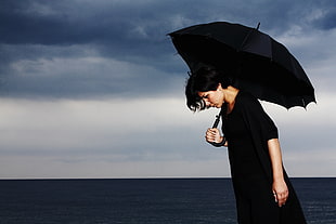 woman holding black umbrella