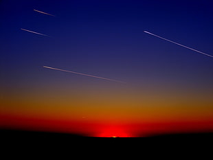 shooting stars passing during sunset HD wallpaper