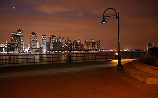 city during nighttime near body of water HD wallpaper