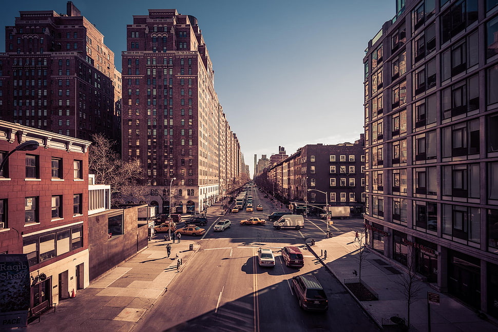 high angle photography of vehicles passing through buildings HD wallpaper