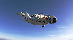 person wearing white suit while skydiving