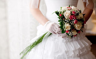 woman in wedding dress holding flower bouquet HD wallpaper