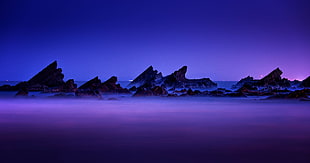 landscape photo of sea shore during night time HD wallpaper