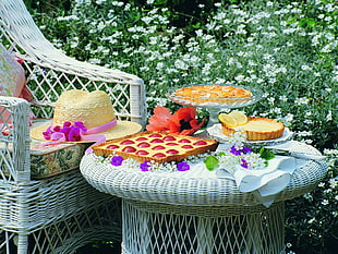 photo of varieties of desserts on wicker table beside yellow straw hat on wicker chair HD wallpaper