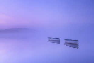 two canoe on misty body of water near island HD wallpaper