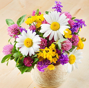 assorted flowers on wooden surface