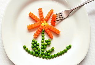 green peas and carrots on white ceramic plate with aluminum fork HD wallpaper