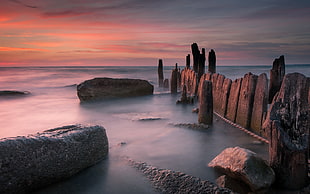 rock formation with body of water landscape photography