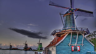 teal and brown wooden windmill painting